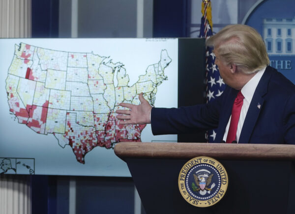 El presidente Donald Trump mira un mapa mientras habla durante una conferencia de prensa en la Casa Blanca el 23 de julio de 2020. (Drew Angerer/Getty Images)