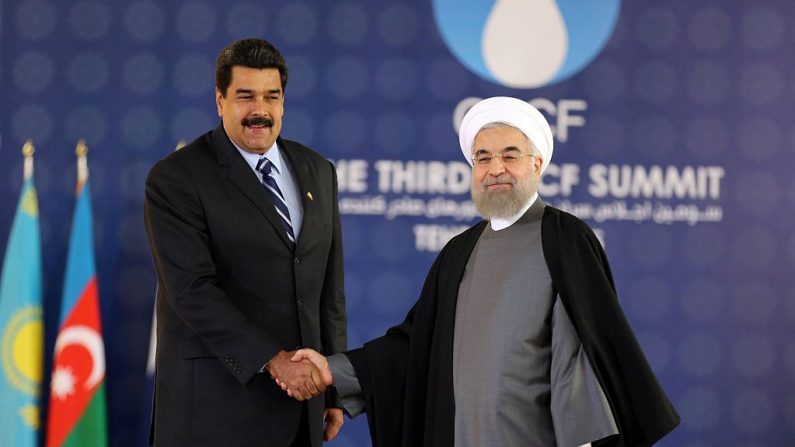 El líder iraní Hassan Rohaní (d) y su homólogo venezolano Nicolás Maduro se dan la mano durante la cumbre del Foro de Países Exportadores de Gas (GECF) en Teherán (Irán) el 23 de noviembre de 2015. (ATTA KENARE/AFP a través de Getty Images)
