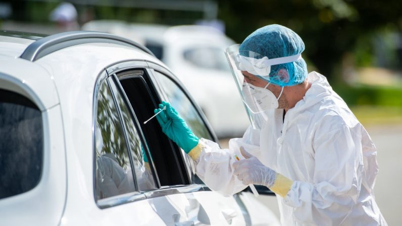 El personal médico que usa trajes de protección PPE prueba a los automovilistas para detectar la infección por covid-19, en una parada de descanso en la autopista A8, en Baviera, el 20 de agosto de 2020, cerca de Traunstein, Alemania. (Lennart Preiss/Getty Images)