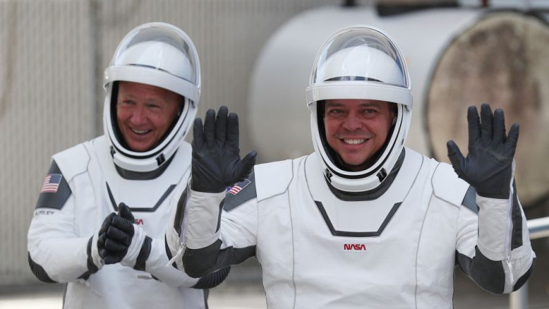 Los astronautas de la NASA Bob Behnken (d) y Doug Hurley (i) salen del Edificio de Operaciones y Caja en su camino hacia el cohete SpaceX Falcon 9 con la nave espacial Crew Dragon en la plataforma de lanzamiento 39A en el Centro Espacial Kennedy el 30 de mayo de 2020 en Cabo Cañaveral, Florida (EE.UU.). (Foto de Joe Raedle/Getty Images)