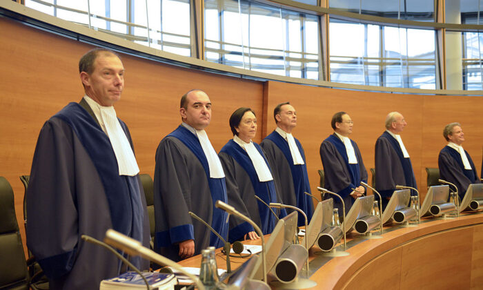 The judges of the International Tribunal for the Law of the Sea (ITLOS), stand in the courtroom prior to delivering the tribunals order on the case of Greenpeace ship Arctic Sunrise on November 22, 2013 in Hamburg. As with a tribunal hearing on November 6, Russia did not attend Friday's ruling at the German-based International Tribunal for the Law of the Sea, based in the northern port city of Hamburg. AFP PHOTO / PATRICK LUX        (Photo credit should read PATRICK LUX/AFP via Getty Images)
