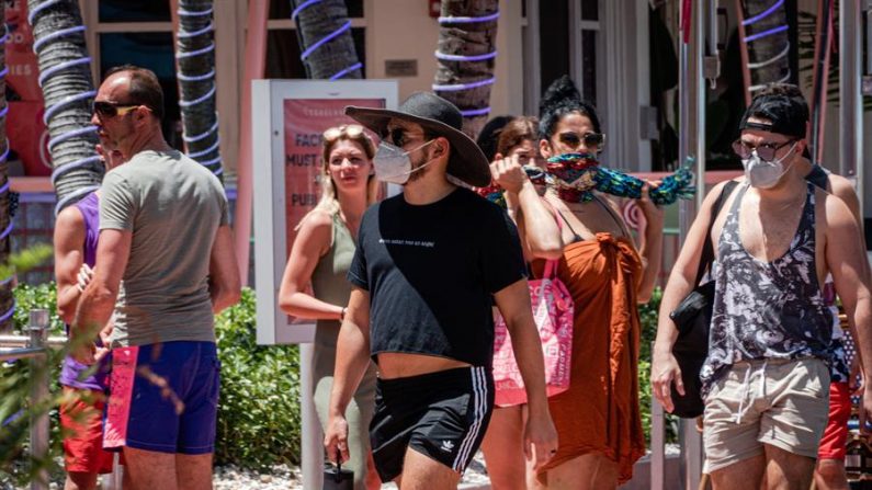 Personas usando tapabocas pasean en el paseo turístico de Ocean Drive en Miami Beach, Florida. EFE/Giorgio Viera/Archivo
