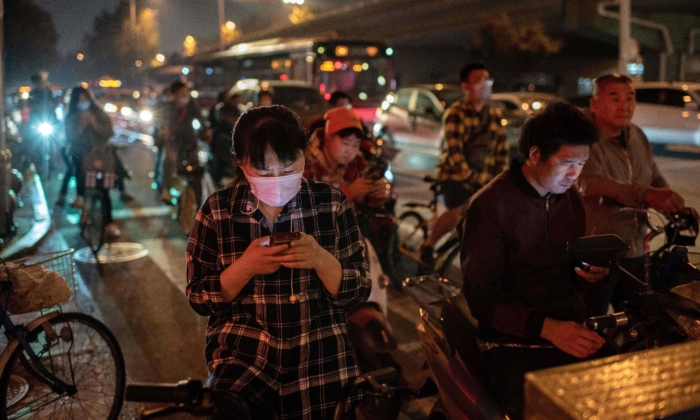 Una mujer con mascarilla facial se desplaza en una calle de Beijing en horas de la tarde en Beijing el 28 de septiembre de 2020. (NICOLAS ASFOURI/AFP vía Getty Images)