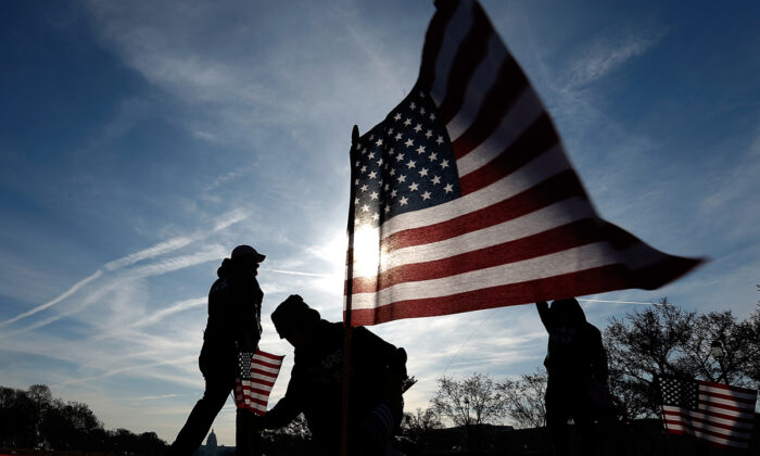 Veteranos del ejército de EE.UU. colocan 1892 banderas estadounidenses en el National Mall de Washington el 27 de marzo de 2014. (Win McNamee/Getty Images)