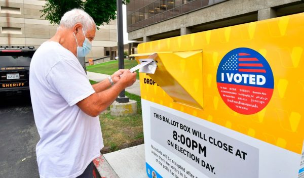 Un votante deja su boleta para las elecciones de EE.UU. de 2020 en una urna oficial en el Registro del Condado de Los Ángeles en Norwalk, California, el 19 de octubre de 2020. (Foto de FREDERIC J. BROWN/AFP vía Getty Images)