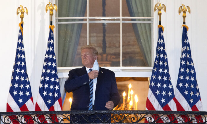 El presidente Donald Trump se quita la mascarilla tras su regreso a la Casa Blanca el 5 de octubre de 2020. (Win McNamee/Getty Images)