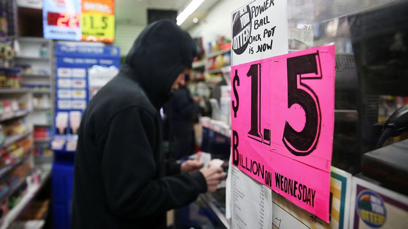 La gente compra boletos de lotería en una tienda de revistas el 13 de enero de 2016 en la ciudad de Nueva York. (Foto de Spencer Platt/Getty Images)
