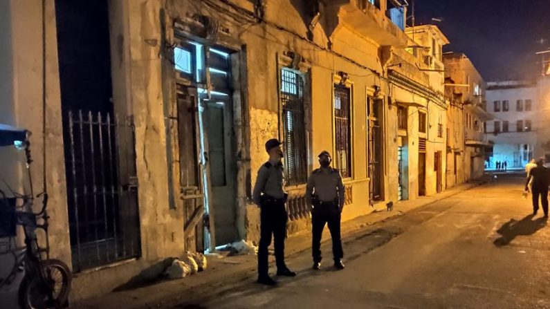 Dos policías permanecen afuera de la casa donde se encontraban los disidentes en huelga de hambre y sed el 26 de noviembre de 2020, en la barriada de San Isidro, en La Habana (Cuba). EFE/Atahualpa Americe