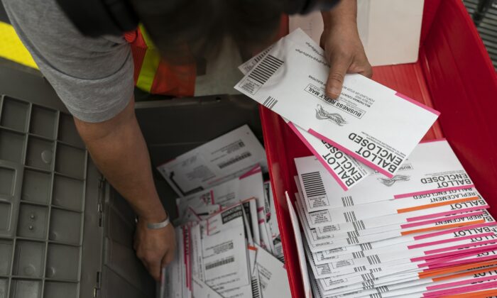 Un trabajador electoral clasifica las boletas enviadas a la Oficina de Elecciones del Condado de Multnomah, en Portland, Oregón, el 2 de noviembre de 2020. (Nathan Howard/Getty Images)