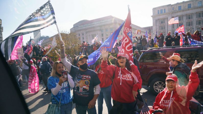 Los partidarios aplauden cuando la caravana que lleva al presidente Donald Trump pasa por la Plaza Freedom en Washington el 14 de noviembre de 2020. (Mandel Ngan/AFP vía Getty Images)
