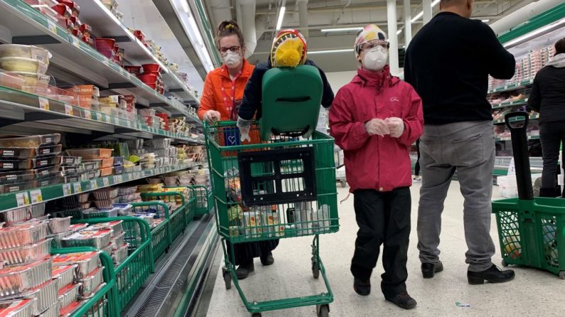 A woman and a child wear face masks as they do their shopping in a supermarket in Vaasa, Finland, on March 28, 2020, amid the coronavirus COVID-19 pandemic. (Photo by Olivier MORIN / AFP) (Photo by OLIVIER MORIN/AFP via Getty Images)
