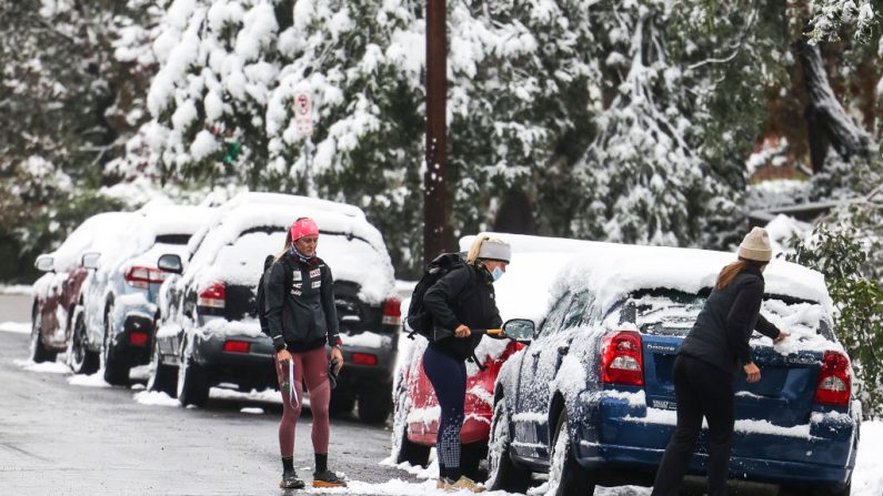 La gente limpia las ventanas de sus automóviles durante una tormenta de nieve a principios de la temporada el 9 de septiembre de 2020 en Boulder, Colorado (EE.UU.). (Foto de Michael Ciaglo / Getty Images)