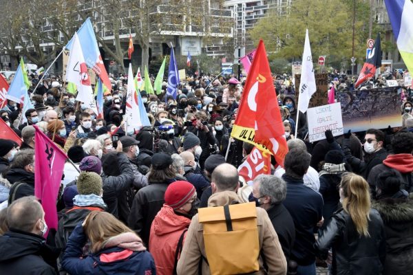 Los manifestantes se reúnen durante una protesta contra un proyecto de ley que restringiría el intercambio de imágenes de la policía, el 5 de diciembre de 2020 en Lille, norte de Francia. (Foto de FRANCOIS LO PRESTI / AFP a través de Getty Images)