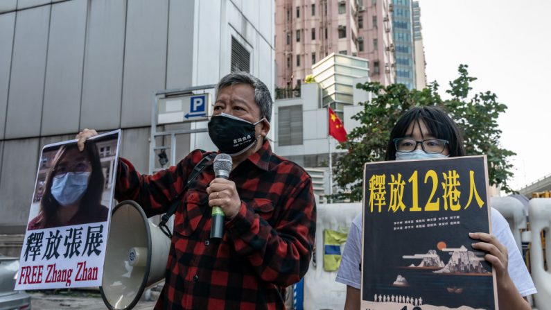 Activistas prodemocracia sostienen carteles que muestran el apoyo a doce residentes de Hong Kong detenidos en China continental y al exabogado Zhang Zhan frente a la Oficina de Enlace del Gobierno Popular Central el 28 de diciembre de 2020 en Hong Kong, China. (Foto de Anthony Kwan/Getty Images)