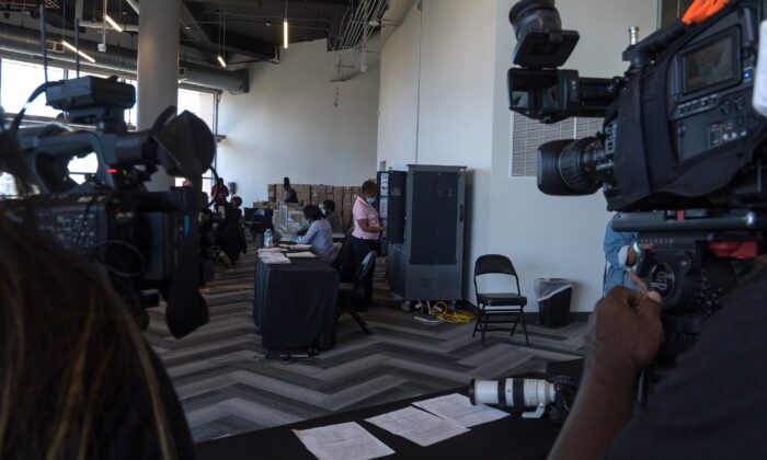 Equipos de medios filman mientras los trabajadores electorales procesan las papeletas de voto en ausencia, en el State Farm Arena, en Atlanta, Georgia, el 2 de noviembre de 2020. (Megan Varner/Getty Images)