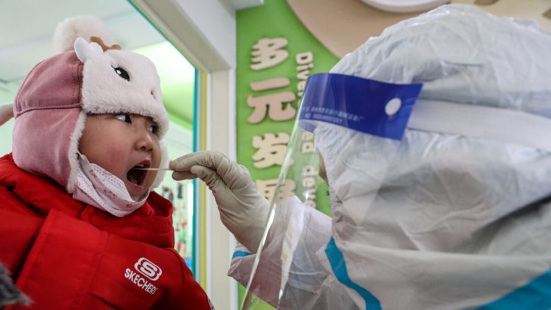 Le realizan un hisopado por COVID-19 a una niña en Shenyang, China, el 1 de enero de 2021. (STR/AFP vía Getty Images)
