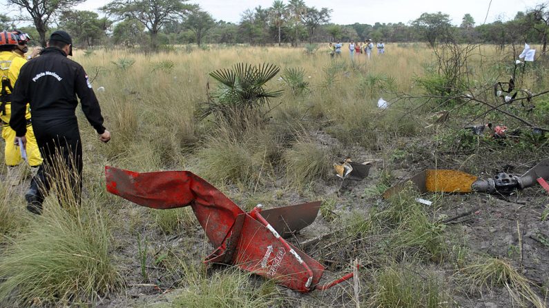 Foto de archivo muestra a rescatistas que caminan entre los escombros de un helicóptero siniestrado en Paraguay, el 3 de febrero de 2013. (Roque Gonzalez / AFP a través de Getty Images)