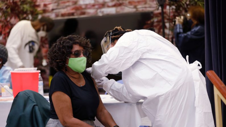 Una trabajadora de la salud se prepara para administrar la vacuna contra COVID-19 a una residente que vive en el vecindario de Jackson Heights en la Iglesia Bautista Misionera St. Johns el 10 de enero de 2021 en Tampa, Florida (EE.UU.). (Octavio Jones / Getty Images)