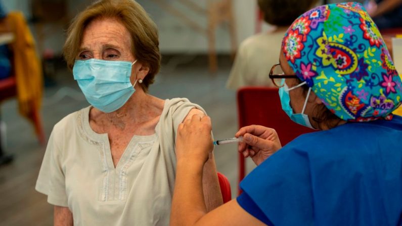 Una trabajadora de la salud administra una dosis de la vacuna Coronavac a una mujer en un centro de vacunación en el Parque Bicentenario, en Santiago, Chile, el 10 de febrero de 2021. (Martin Bernetti / AFP a través de Getty Images)