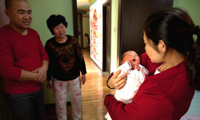 Una mujer sostiene a una niña recién nacida en el hospital de maternidad Antai, en Beijing, el 26 de enero de 2012. (Ed Jones/AFP/Getty Images)