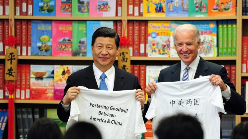 El entonces vicepresidente de Estados Unidos, Joe Biden, y el entonces sublíder de China, Xi Jinping, muestran camisetas con un mensaje que les entregaron los estudiantes de la Escuela de Aprendizaje de Estudios Internacionales de Southgate, en las afueras de Los Ángeles, California, el 17 de febrero de 2012. (FREDERIC J. BROWN/AFP vía Getty Images)
