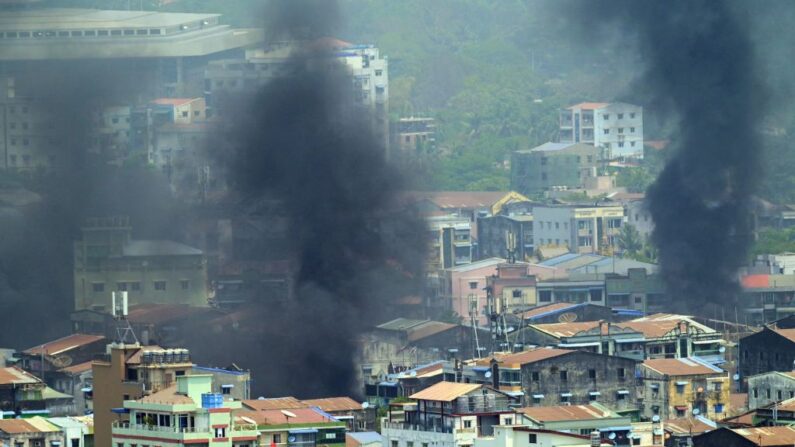 El humo se eleva sobre el municipio de Thaketa en Rangún, Birmania, el 27 de marzo de 2021, mientras las fuerzas de seguridad continúan reprimiendo las protestas contra el golpe militar. (STR / AFP vía Getty Images)