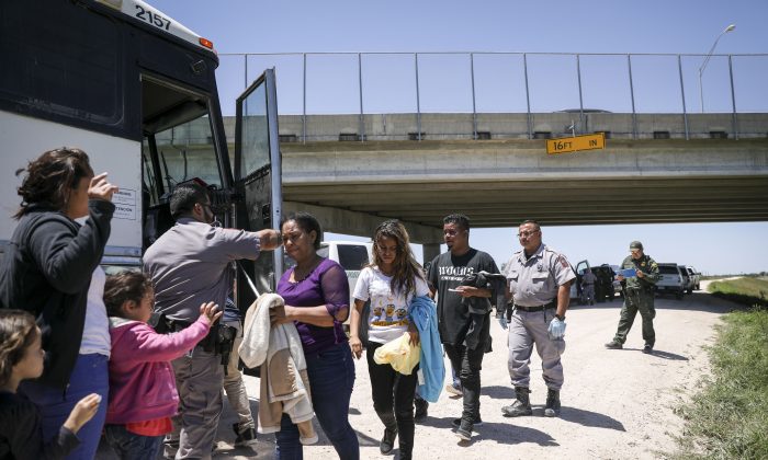 Grupo de extranjeros ilegales sube a un autobús con destino a las instalaciones de procesamiento de la Patrulla Fronteriza después de ser detenidos cerca de McAllen, Texas, el 18 de abril de 2019. (Charlotte Cuthbertson/The Epoch Times)