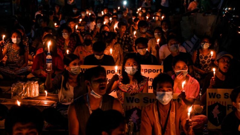 Esta foto tomada el 3 de abril de 2021 muestra a los manifestantes participando en una protesta a la luz de las velas contra el golpe militar en el municipio de Tamwe de Rangún, Birmania. (STR / AFP vía Getty Images)