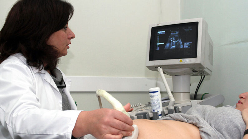 Una mujer embarazada observa a su bebé en el monitor mientras un médico le realiza una ecografía en Tirana el 9 de noviembre de 2011. (GENT SHKULLAKU/AFP via Getty Images)