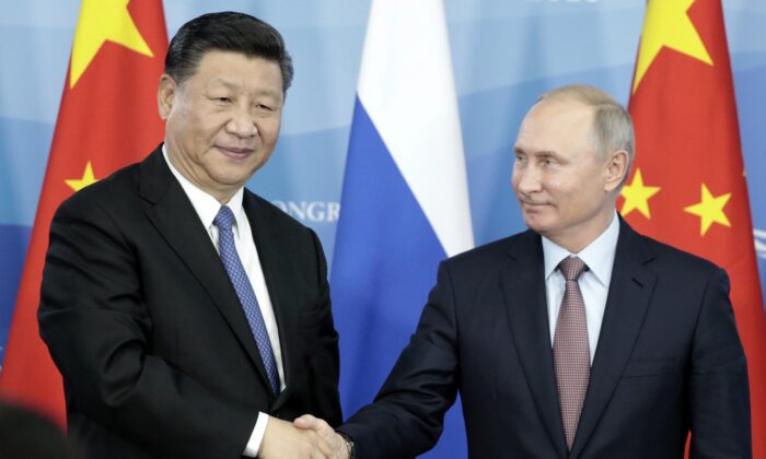 El presidente ruso, Vladímir Putin (Der.), estrecha la mano del líder chino, Xi Jinping, durante una ceremonia de firma tras las conversaciones entre Rusia y China al margen del Foro Económico Oriental en Vladivostok, el 11 de septiembre de 2018. (Sergei Chirikov/AFP/Getty Images)