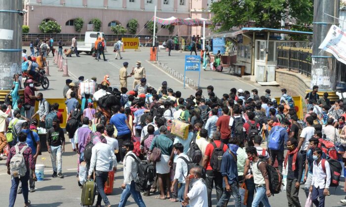 La gente espera en la cola fuera de una estación de tren para volver a casa durante el primer día de un bloqueo de 10 días impuesto por el gobierno para frenar la propagación de COVID-19 en Secunderabad, India, el 12 de mayo de 2021. (Noah Seelam/AFP vía Getty Images)
