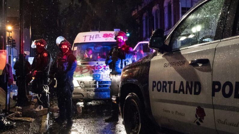 La policía detiene a los pasajeros de una furgoneta relacionada con los disturbios, en Portland, Oregón, el 11 de octubre de 2020. (Nathan Howard/Getty Images)
