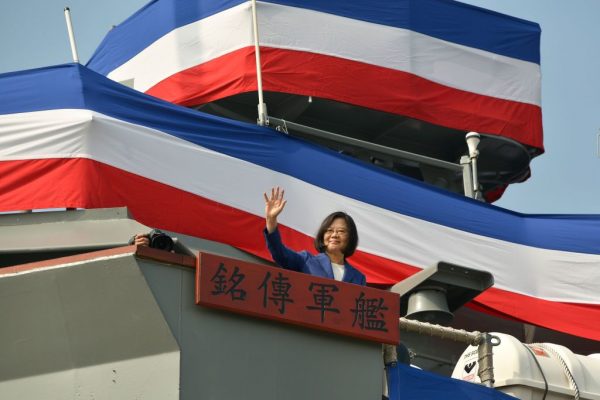 La presidenta de Taiwán, Tsai Ing-Wen, saluda a los invitados reunidos desde la cubierta del barco "Ming Chuan" durante una ceremonia para comisionar dos barcos de misiles guiados clase Perry de Estados Unidos a la Armada de Taiwán, en el puerto sur de Kaohsiung, el 8 de noviembre, 2018. (Chris Stowers/AFP/Getty Images)