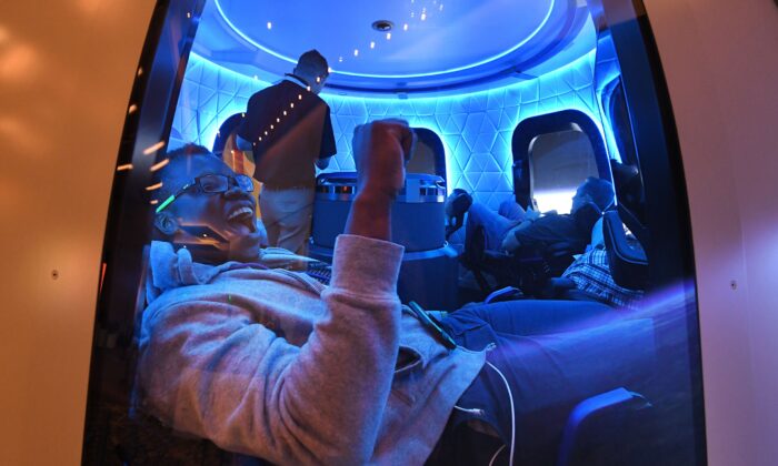 Unos participantes disfrutan del simulador espacial de Blue Origin en el Hotel Aria en Las Vegas, Nevada, el 5 de junio de 2019, durante la conferencia Amazon Re:MARS sobre robótica e inteligencia artificial. (MARK RALSTON/AFP vía Getty Images)