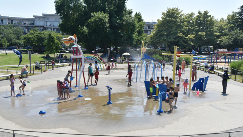 Los niños se refrescan en un parque acuático comunitario en un día de calor abrasador en Richmond, Columbia Británica, Canadá, el 29 de junio de 2021. (Don MacKinnon/AFP vía Getty Images)