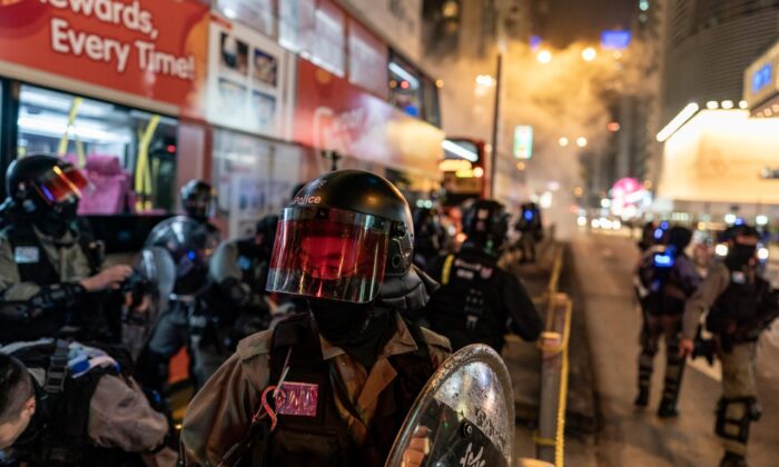 La policía antidisturbios reacciona tras disparar gases lacrimógenos para dispersar a los manifestantes en Hong Kong, China, el 24 de diciembre de 2019. (Anthony Kwan/Getty Images)