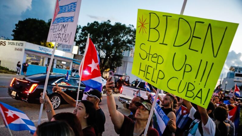 La gente sostiene banderas y pancartas cubanas durante una protesta de apoyo a los cubanos que se manifiestan contra su gobierno, en Miami, Florida, el 16 de julio de 2021. (Eva Marie UZCATEGUI/AFP vía Getty Images)