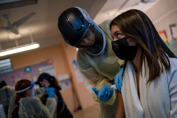 Un trabajador sanitario aplica una inyección de la vacuna Moderna Covid-19 en un centro de vacunación de la Guardia Nacional de Puerto Rico durante un programa de vacunación prioritaria de Covid-19 para los residentes de la isla de Vieques, Puerto Rico, el 10 de marzo de 2021.  (Foto de RICARDO ARDUENGO/AFP a través de Getty Images)