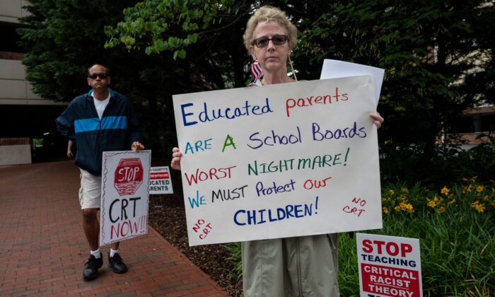 La gente sostiene pancartas durante una manifestación contra la Teoría Crítica de la Raza (TCR) que se enseña en las escuelas en el centro del Gobierno del Condado de Loudoun en Leesburg, Virginia, el 12 de junio de 2021. (Andrew Caballero-Reynolds/AFP vía Getty Images)