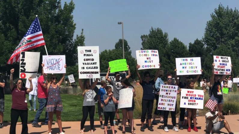 Varias personas se reúnen en el exterior de UCHealth of the Rockies para protestar por la decisión del sistema sanitario de despedir a los empleados que rechacen la vacuna en Loveland, Colorado, el 13 de agosto de 2021. (Allan Stein/The Epoch Times)