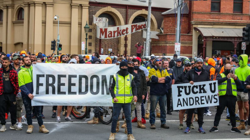 Se ven manifestantes frente a la oficina de la CFMEU mientras miles de personas marchan por Melbourne después de que el gobierno estatal anunció la suspensión de la construcción el 21 de septiembre de 2021 en Melbourne, Australia. (Asanka Ratnayake/Getty Images)