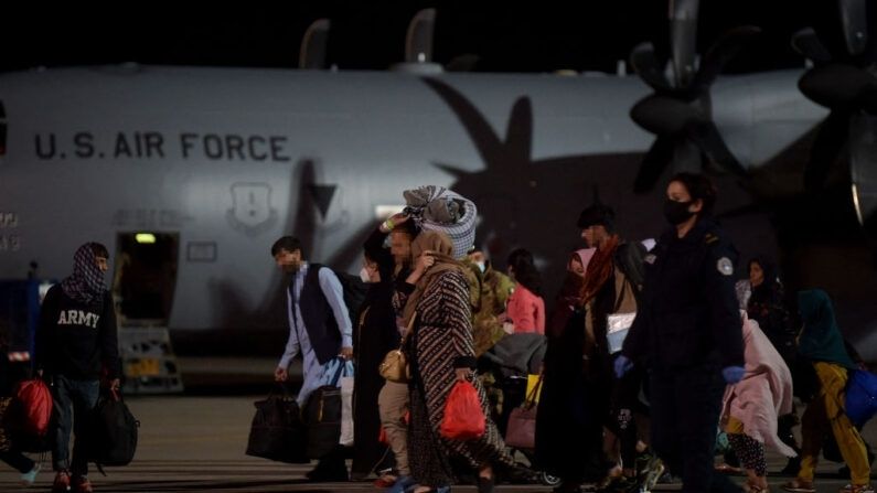 Refugiados afganos, que huyen de la capital afgana, Kabul, salen de un avión de las fuerzas aéreas estadounidense a su llegada al aeropuerto internacional de Pristina, Kosovo, el 29 de agosto de 2021, donde serán acogidos hasta que se tramiten sus solicitudes de asilo. (Armend Nimani / vía Getty Images)