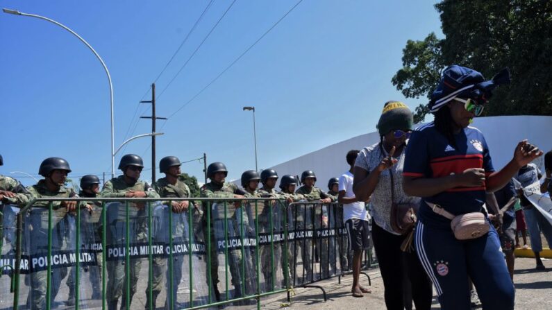 Migrantes africanos protestan ante a una línea de policías frente al centro de detención de migrantes Siglo XXI. Exigen a las autoridades mexicanas que aceleren las visas humanitarias que les permitirían cruzar México en su camino a EE.UU., en Tapachula, estado de Chiapas, México, en la frontera con Guatemala, el 28 de agosto de 2019. (ISAAC GUZMAN/AFP vía Getty Images)