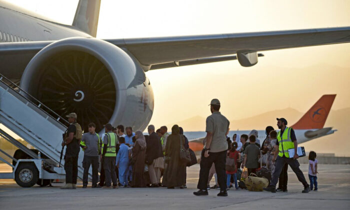 Los pasajeros se preparan para subir a un avión de Qatar Airways en el aeropuerto de Kabul, Afganistán, el 9 de septiembre de 2021. (Wakil Kohsar/AFP vía Getty Images)