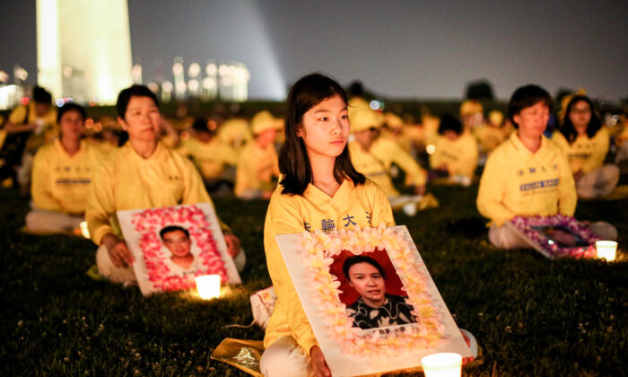 Practicantes de Falun Gong participan el 16 de julio de 2021 delante del Monumento a Washington, EE. UU., en una vigilia a la luz de las velas en recuerdo de las víctimas tran 22 años de persecución que sufren en China. (Samira Bouaou/The Epoch Times)