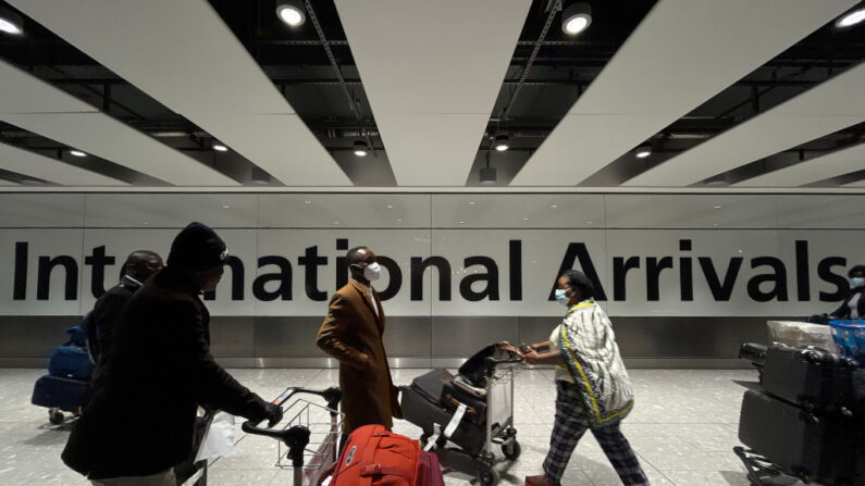 Pasajeros internacionales caminan por la zona de llegadas de la Terminal 5 del aeropuerto de Heathrow el 26 de noviembre de 2021 en Londres, Inglaterra. (Leon Neal/Getty Images)