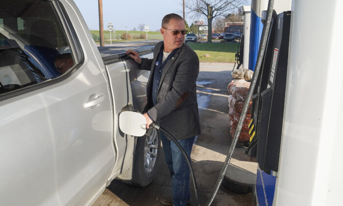 Greg Alexander llena su camioneta con gasolina en Croswell, Michigan, el 10 de diciembre de 2021. (Steven Kovac/The Epoch Times)
