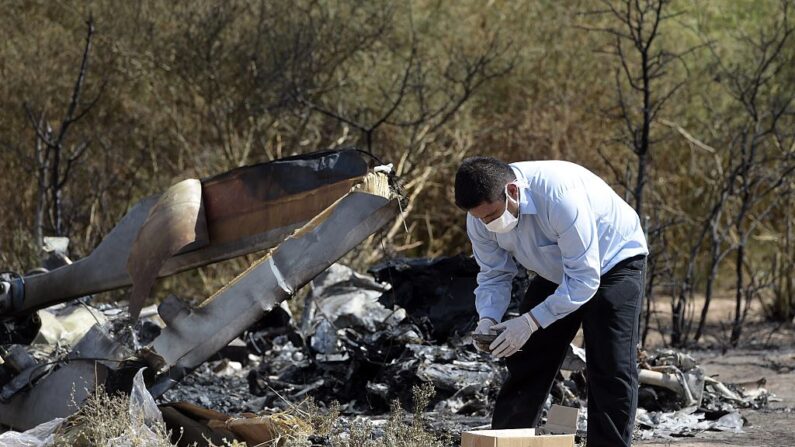 En una foto de archivo, un hombre trabaja entre los restos de dos helicópteros que colisionaron en el aire cerca de Villa Castelli, en la provincia argentina de La Rioja, el 10 de marzo de 2015. (Juan Mabromata/AFP vía Getty Images)