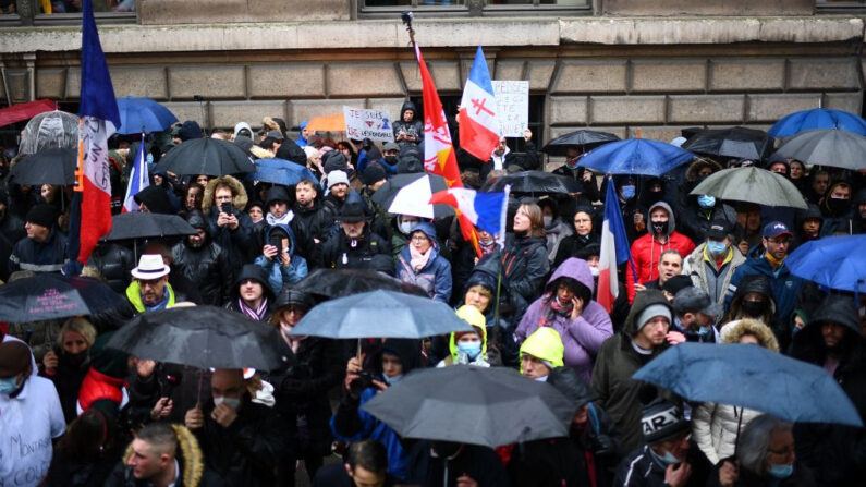 Manifestantes se reúnen durante una protesta contra el certificado sanitario y las vacunas obligatorias contra la covid-19 en la Place du Palais-Royal, París (Francia), el 8 de enero de 2022. (Christophe Archambault/AFP vía Getty Images)
