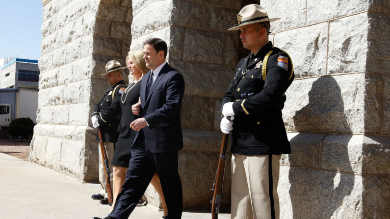 El gobernador de Arizona Doug Ducey y su esposa Angela salen del Capitolio del estado para recibir los restos del senador John McCain, en las afueras de la Rotonda del Capitolio, el 29 de agosto de 2018, en Phoenix, Arizona. (Ralph Freso/Getty Images)